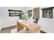 Chic home office showcasing a sleek wooden desk, modern art, and large windows at 2859 Dartmouth N Ave, St Petersburg, FL 33713