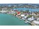 Stunning aerial view of waterfront homes, docks, and lush landscapes in a picturesque community at 31 Dolphin Dr, Treasure Island, FL 33706