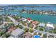 Aerial view showcasing a charming home with a private dock and lush surroundings in a desirable waterfront community at 31 Dolphin Dr, Treasure Island, FL 33706