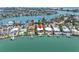 Wide aerial view of waterfront homes, private docks and lush landscaping in a desirable community at 31 Dolphin Dr, Treasure Island, FL 33706