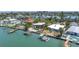 Well-maintained waterfront home with a lush backyard, private dock, boat lift, and swimming pool in a quiet community at 31 Dolphin Dr, Treasure Island, FL 33706