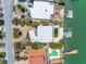 Aerial view of waterfront property featuring a pool, private dock, and lush landscaping at 31 Dolphin Dr, Treasure Island, FL 33706