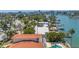 Waterfront home featuring lush landscaping, and picturesque water views in an established and peaceful neighborhood at 31 Dolphin Dr, Treasure Island, FL 33706