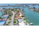 Aerial view of waterfront home with dock, pool, and stunning water views at 31 Dolphin Dr, Treasure Island, FL 33706