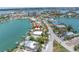 Panoramic aerial view showcasing a waterfront property with a private dock and stunning views of the surrounding community at 31 Dolphin Dr, Treasure Island, FL 33706