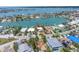 Wide aerial view of waterfront home featuring a private dock and lush surroundings in a desirable community at 31 Dolphin Dr, Treasure Island, FL 33706