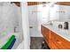 Bathroom featuring modern fixtures, a double vanity, and a tub with shower at 31 Dolphin Dr, Treasure Island, FL 33706