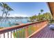 Spacious deck overlooks waterfront views and lush landscaping, perfect for outdoor relaxation and entertainment at 31 Dolphin Dr, Treasure Island, FL 33706