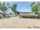 Single story home with light colored gravel yard and manicured shrubbery at 31 Dolphin Dr, Treasure Island, FL 33706