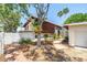 Charming home exterior with lush landscaping and inviting entryway at 31 Dolphin Dr, Treasure Island, FL 33706