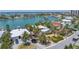 Single-Gathering home featuring a large lot with mature palm trees and lush landscaping in a beautiful neighborhood at 31 Dolphin Dr, Treasure Island, FL 33706