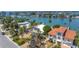 Waterfront property boasts lush palm trees, mature landscaping, and picturesque water views in an established neighborhood at 31 Dolphin Dr, Treasure Island, FL 33706