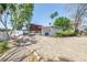 Well-maintained home featuring a gravel driveway and a detached garage at 31 Dolphin Dr, Treasure Island, FL 33706