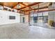 Bright living room featuring wood ceilings, a brick fireplace, and waterfront views through floor-to-ceiling glass windows at 31 Dolphin Dr, Treasure Island, FL 33706
