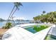Exterior view of a home with a waterside pool and access to a private dock at 31 Dolphin Dr, Treasure Island, FL 33706