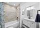 Updated bathroom with modern vanity, shower-tub combo, and decorative tile flooring at 3102 W Horatio St # 13, Tampa, FL 33609
