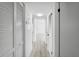 Bright hallway featuring wood-look tile floors and closet doors at 3102 W Horatio St # 13, Tampa, FL 33609