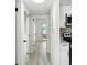 Hallway leading to the kitchen featuring white cabinetry, and access to the exterior at 3102 W Horatio St # 13, Tampa, FL 33609