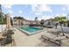 Community pool with lounge seating in a fenced in area by the condo buildings at 3102 W Horatio St # 13, Tampa, FL 33609