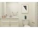 Cozy bathroom features a vanity, toilet, and a framed geometric print above the commode at 32056 Griffin Sands Ln, San Antonio, FL 33576