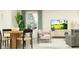 Cozy living space with a dining area and modern seating arrangement with a coastal television display at 32056 Griffin Sands Ln, San Antonio, FL 33576