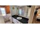 Bathroom featuring a vanity with a dark countertop, a sink, and a large mirror at 3301 Alt 19 # 500, Palm Harbor, FL 34683