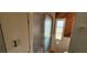 Bathroom with a glass-enclosed shower, storage shelves, and a window for natural light at 3301 Alt 19 # 500, Palm Harbor, FL 34683