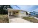 Well-maintained single-story home with covered parking and manicured landscaping at 3301 Alt 19 # 500, Palm Harbor, FL 34683
