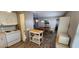Kitchen featuring white appliances, wooden cabinets, and dining area with table and chairs at 3301 Alt 19 # 500, Palm Harbor, FL 34683