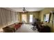 Cozy living room featuring a plush sofa, ceiling fan, and natural light from the windows at 3301 Alt 19 # 500, Palm Harbor, FL 34683