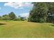 Large lawn with mature landscaping and blue skies at 3311 Stonebridge Trl, Valrico, FL 33596
