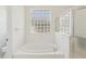 Bathroom with garden tub, glass block window, and separate shower at 3311 Stonebridge Trl, Valrico, FL 33596