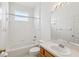 A bright bathroom offers a tub with shower and vanity at 3311 Stonebridge Trl, Valrico, FL 33596