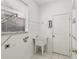 Laundry room featuring a utility sink, window, and built-in shelving at 3311 Stonebridge Trl, Valrico, FL 33596