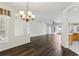 Open living room showcasing hardwood floors with eat in kitchen in the background at 3311 Stonebridge Trl, Valrico, FL 33596