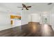Bright living room featuring hardwood floors and natural light with kitchen view at 3311 Stonebridge Trl, Valrico, FL 33596