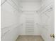 Organized walk-in closet with multiple shelves and hanging rods at 3311 Stonebridge Trl, Valrico, FL 33596