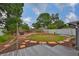 Backyard with a wooden deck surrounded by trees and grass at 3411 W Beach St, Tampa, FL 33607
