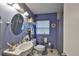 Bathroom featuring a vanity sink, toilet, shower, and a window at 3411 W Beach St, Tampa, FL 33607