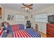 Bright bedroom with two beds, a ceiling fan, a computer desk and decorative wall art at 3411 W Beach St, Tampa, FL 33607