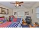Shared bedroom with twin beds, a ceiling fan, a desk and pictures decorating the walls at 3411 W Beach St, Tampa, FL 33607