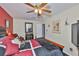 A bedroom featuring a ceiling fan, comfortable dark wood bed frame, and ample natural light at 3411 W Beach St, Tampa, FL 33607