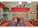 Warm dining area featuring decorative lighting, red accents, wood furnishings, and natural light at 3411 W Beach St, Tampa, FL 33607