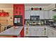 Spacious kitchen featuring white cabinets, brick oven surround, tile floors, and modern appliances at 3411 W Beach St, Tampa, FL 33607
