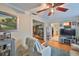 Inviting living room with hardwood floors, an entertainment center, and a peek into the dining area at 3411 W Beach St, Tampa, FL 33607