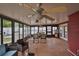 Relaxing sunroom with multiple seating areas, ceiling fans, and windows at 3411 W Beach St, Tampa, FL 33607