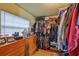 Spacious walk-in closet featuring wooden drawers, shelves, hanging racks and a window for natural light at 3411 W Beach St, Tampa, FL 33607