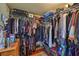 A well-organized walk-in closet featuring wood floor, shelves, and hanging racks for ample storage at 3411 W Beach St, Tampa, FL 33607
