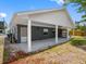 A covered back porch with white columns and a screened door provides shade and outdoor enjoyment at 366 12Th Ave, Indian Rocks Beach, FL 33785