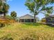 A well-maintained backyard with green grass, a wooden fence, and a partial view of the house's exterior at 366 12Th Ave, Indian Rocks Beach, FL 33785